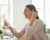 woman smiling opening letter direct mail