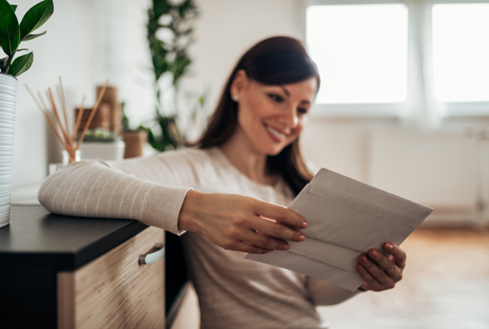 woman at home reading letters