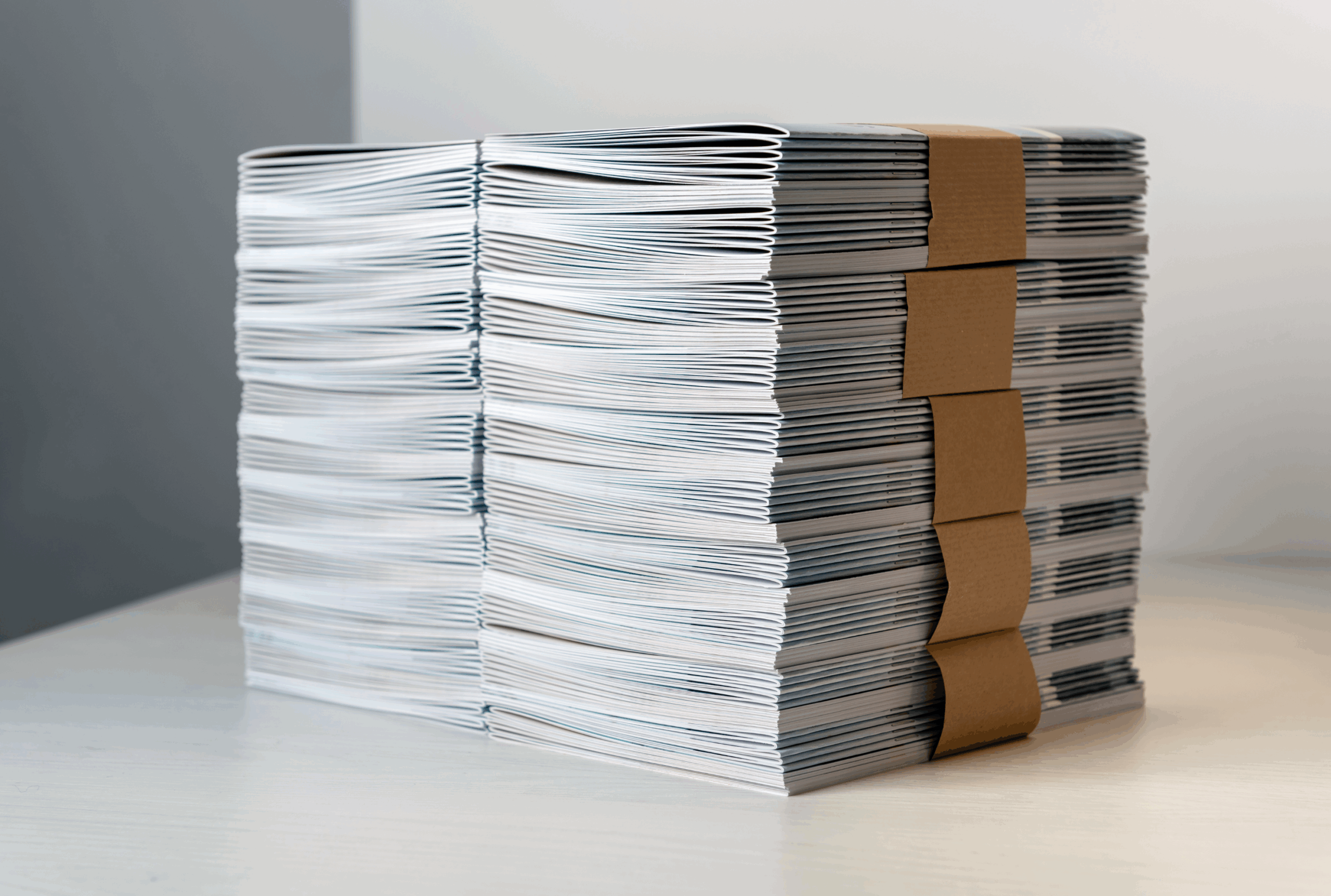 Stack of printed magazines on a table