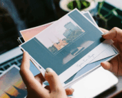 female hands holding postcards