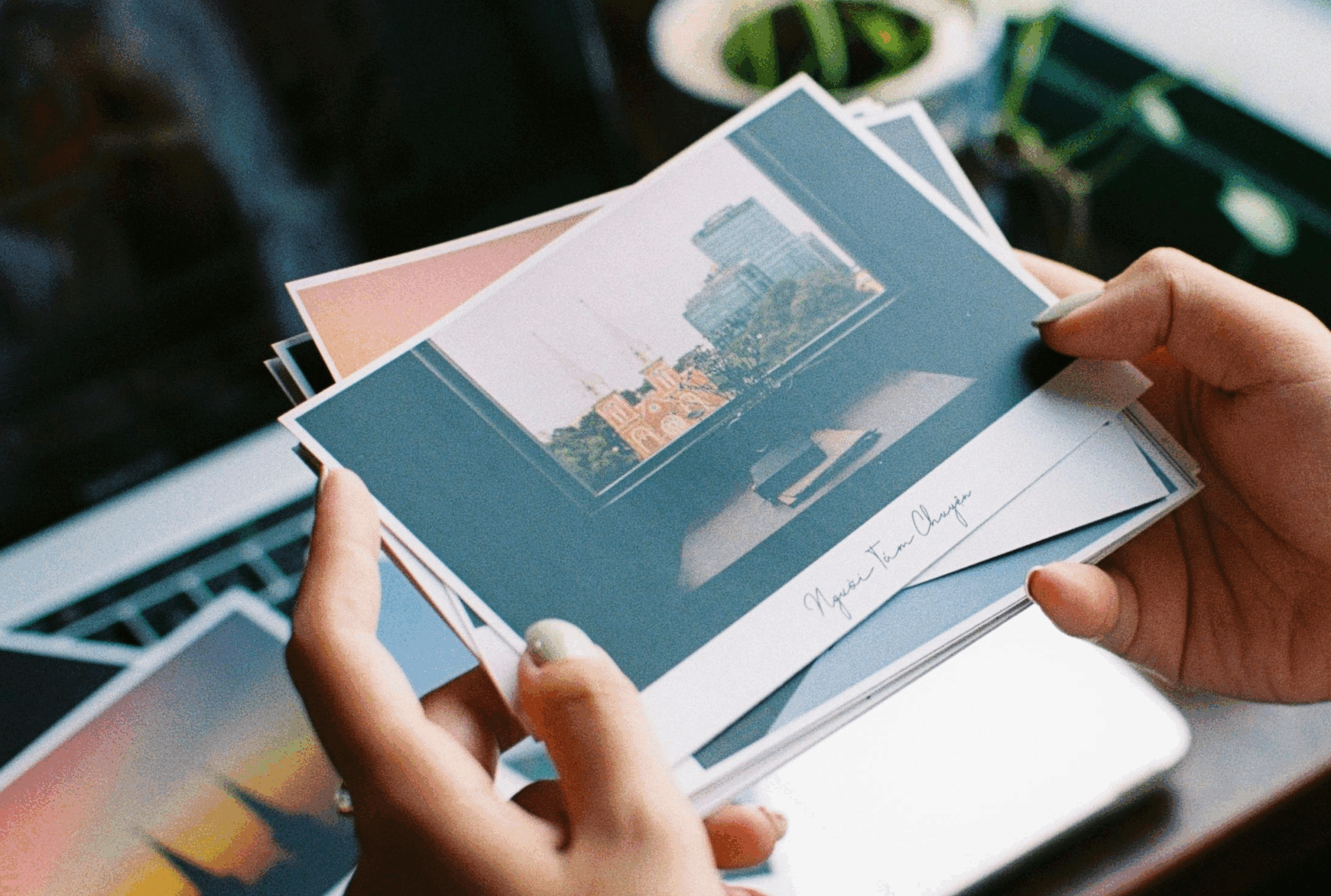 female hands holding postcards
